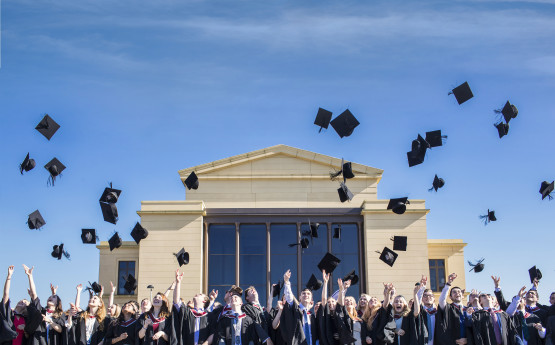 Graduates throwing caps in the air 